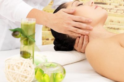 Woman having massage of neck in the spa salon. Beauty treatment concept.